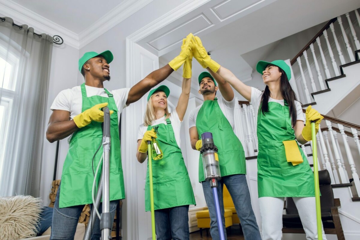 Happy multiracial cleaners giving high five after cleaning.jpg